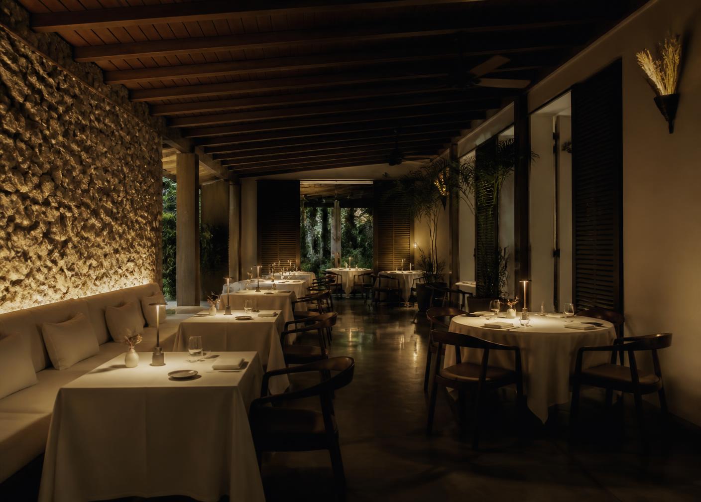 Candlelit dining room with linen tables